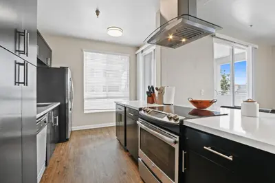 a kitchen with stainless steel appliances and a large window at Spacious 3-Bedroom 3BTH Apt in Marina Del Rey! Pool, Hot Tub in Los Angeles