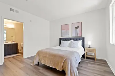 a white bedroom with a bed and a bathroom at 4bd Townhouse - Special Limited Time Offer near Venice Beach! in Los Angeles
