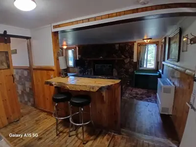 a kitchen with a counter and stools in a house at Big Bear Lake - Tulip Lane Cabin #21 in Big Bear Lake