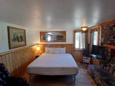 a bedroom with a bed and a tv in it at Big Bear Lake - Tulip Lane Cabin #21 in Big Bear Lake