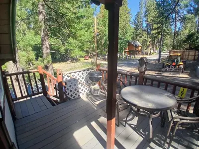 a deck with a table and chairs and a grill at Big Bear Lake - Tulip Lane Cabin #22 in Big Bear Lake