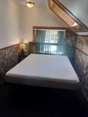 a large white bed in a room with a window at Big Bear Lake - Tulip Lane Cabin #22 in Big Bear Lake