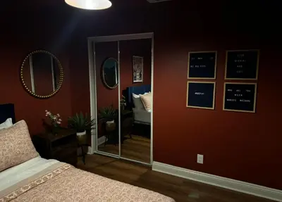 a bedroom with a bed and a mirror on the wall at Cozy and Spacious Duplex in Los Angeles