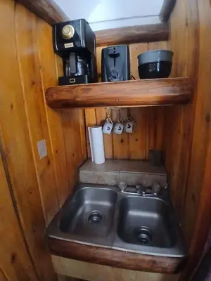 a small kitchen with a sink and a coffee maker at Big Bear Lake - Tulip Lane Cabin #23 - Micro Cabin in Big Bear Lake