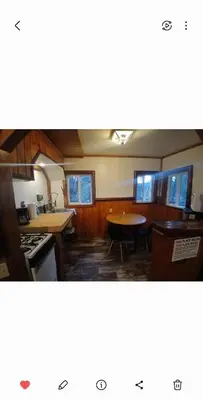 a kitchen with a stove and a table in it at Big Bear Lake - Tulip Lane Cabin #24 in Big Bear Lake
