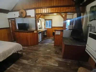 a room with a bed and a kitchen in a house at Big Bear Lake - Tulip Lane Cabin #24 in Big Bear Lake