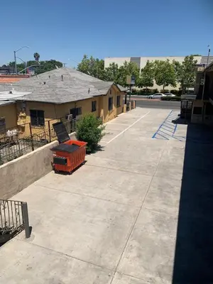 an empty parking lot in front of a building at Hi Rise Motel in Lynwood