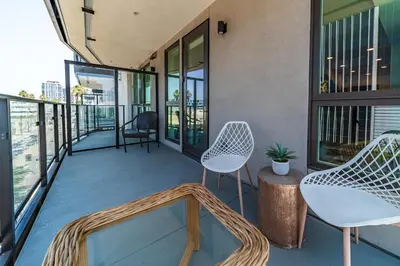 a balcony with two chairs and a table on a building at Sunset Blvd Studio Apt in the Heart of Hollywood in Los Angeles