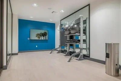 a room with a gym with a blue wall at Sunset Blvd Studio Apt in the Heart of Hollywood in Los Angeles