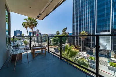 a balcony with a chair and a view of a city at Sunset Blvd Studio Apt in the Heart of Hollywood in Los Angeles