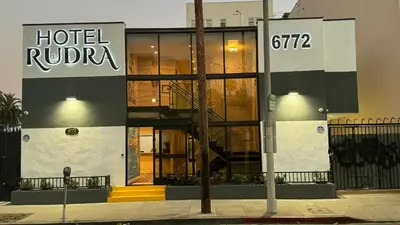 a hotel lobby with a hotelvisor sign on the side of a building at Hotel Rudra - Hollywood in Los Angeles
