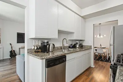 a kitchen with white cabinets and stainless steel appliances at Cozy Oasis in Marina Del Rey!Free Swimming Pool and Parking in Los Angeles