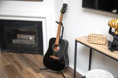 a guitar leaning against a wall next to a fireplace at Cozy Oasis in Marina Del Rey!Free Swimming Pool and Parking in Los Angeles