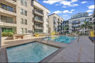 an apartment with a swimming pool in front of a building at Cozy Oasis in Marina Del Rey!Free Swimming Pool and Parking in Los Angeles