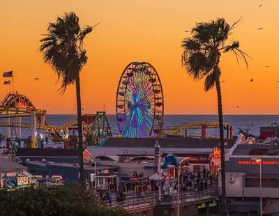 an amusement park with a ferris wheel and palm trees at Splendid 2BR, 2BA Apt 12 Min Walk to SM Pier! in Los Angeles
