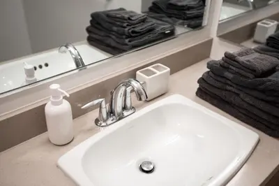 a bathroom sink with a soap dispenser next to a mirror at Beautiful 1BR Apt in Hollywood w Pool and Parking in Los Angeles