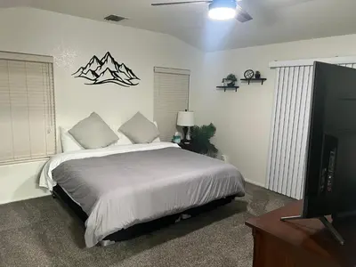 a bedroom with a bed and a flat screen tv at Cheerful 3BR 2BA Sauna Spa Pool Table PPong BBQ More in Lancaster