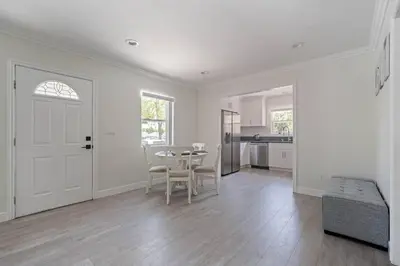a white living room with a table and chairs at Serene Home in Central Burbank in Burbank