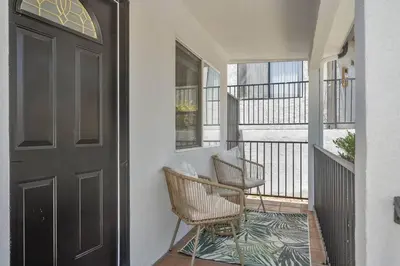 a porch with two chairs and a door at Serene Home in Central Burbank in Burbank