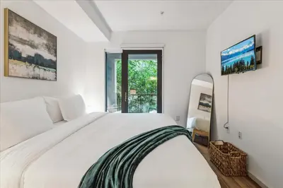 a white bedroom with a large bed and a window at Cozy 1BR apt in Hollywood w Pool, Gym and Parking in Los Angeles