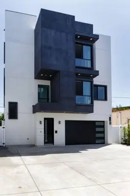 a tall black and white building with a garage at Modern 4 Bedroom Masterpiece With Rooftop Deck in Los Angeles