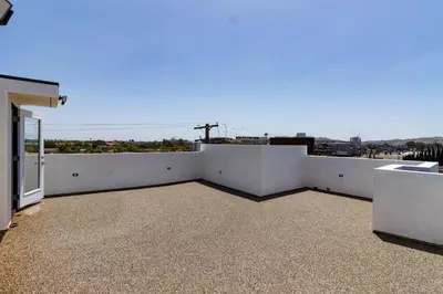 a balcony of a house with a view of a city at Modern 4 Bedroom Masterpiece With Rooftop Deck in Los Angeles