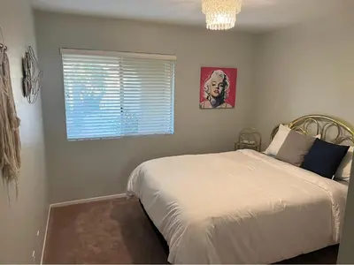 a bedroom with a white bed and a window at Quaint Vintage Ranch Style 4BedRoom 2Bath Sleeps 10 in Lancaster