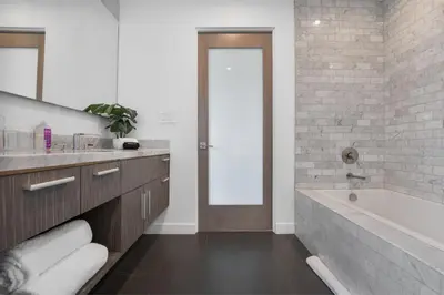 a bathroom with a tub and a sink and a mirror at Maravilla in Los Angeles