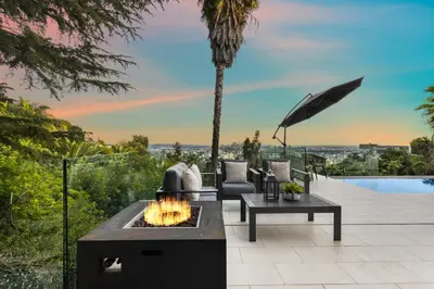 an outdoor patio with a fire pit and an umbrella at Maravilla in Los Angeles