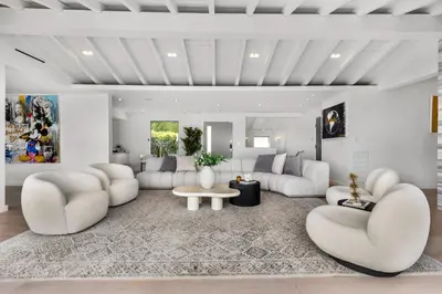 a living room with white couches and a table at Maravilla in Los Angeles