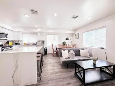 a kitchen and living room with a couch and a table at Cozy 3 BR Townhouse with Balcony in Los Angeles