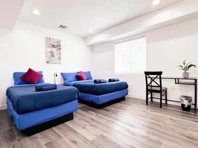 a living room with two beds and a couch at Cozy 3 BR Townhouse with Balcony in Los Angeles