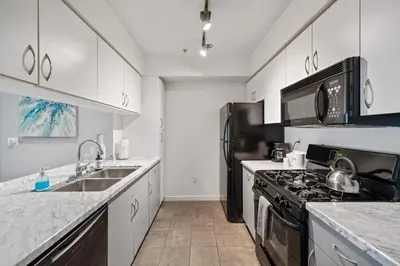 a kitchen with a sink and a stove top oven at Le Reve , 5 min to the beach Luxury Condo in Los Angeles