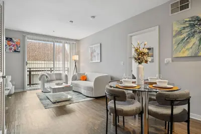 a living room with a table and chairs at Le Reve , 5 min to the beach Luxury Condo in Los Angeles