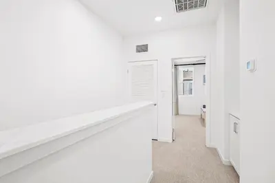 a white room with white walls and a hallway at Luxurious Ontario Townhouse Ideal Family in Ontario