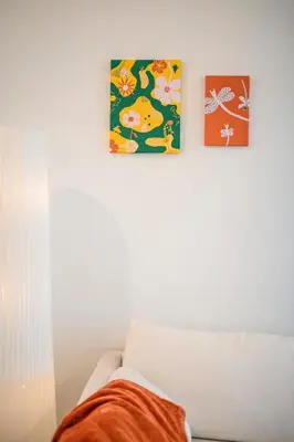 two pictures on a wall above a white couch at Luxurious Ontario Townhouse Ideal Family in Ontario