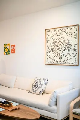 a white couch in a living room with a picture on the wall at Luxurious Ontario Townhouse Ideal Family in Ontario