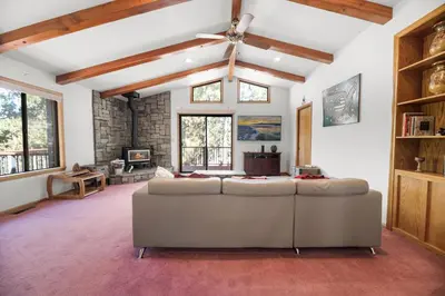 a living room with a couch and a ceiling fan at Silver Rays - Game room with pool table & air hockey! Close to the slopes!! in Big Bear Lake