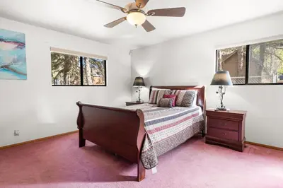 a bedroom with a bed and a ceiling fan at Silver Rays - Game room with pool table & air hockey! Close to the slopes!! in Big Bear Lake