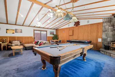a living room with a pool table in it at Silver Rays - Game room with pool table & air hockey! Close to the slopes!! in Big Bear Lake