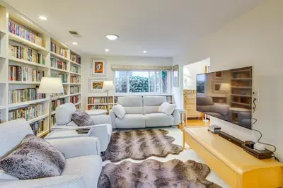 a living room with two couches and a tv at Vibrant Home with Patio - Near Santa Monica Pier! in Los Angeles