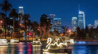 a boat in the water with a city at night at Bright lights central Downtown in Los Angeles