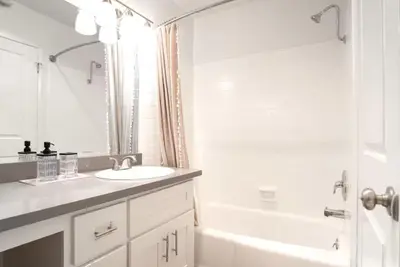 a white bathroom with a sink and a shower at Hollywood Townhome, Resort Amenities, 2 Free Parking Spaces! in Los Angeles