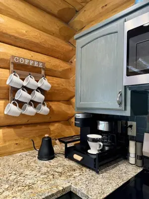 a kitchen with a counter with coffee cups and a microwave at Peppermint Falls Ranch in Ponderosa