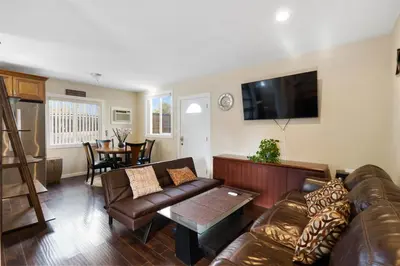 a living room with a couch and a table at 1 bd guest house in LA perfect for long term stay in Los Angeles