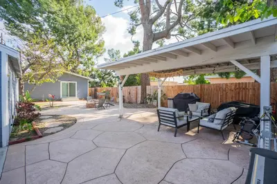 a patio with a white pergola and chairs at 1 bd guest house in LA perfect for long term stay in Los Angeles