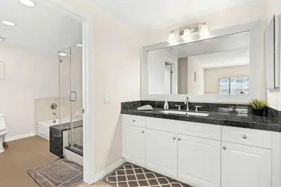 a white bathroom with a sink and a mirror at Charming 2BR2BA Home Near Downtown LA And Walkable Amenities in Monterey Park