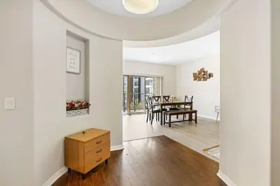 a living room with white walls and a table at Charming 2BR2BA Home Near Downtown LA And Walkable Amenities in Monterey Park