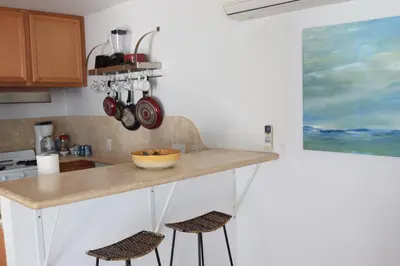 a kitchen with a counter and two stools at Malibu Private Beach Apartments in Malibu