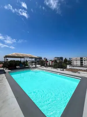 a large blue swimming pool on top of a building at Exceptional 2 BR in Heart of Hollywood 201 in Los Angeles